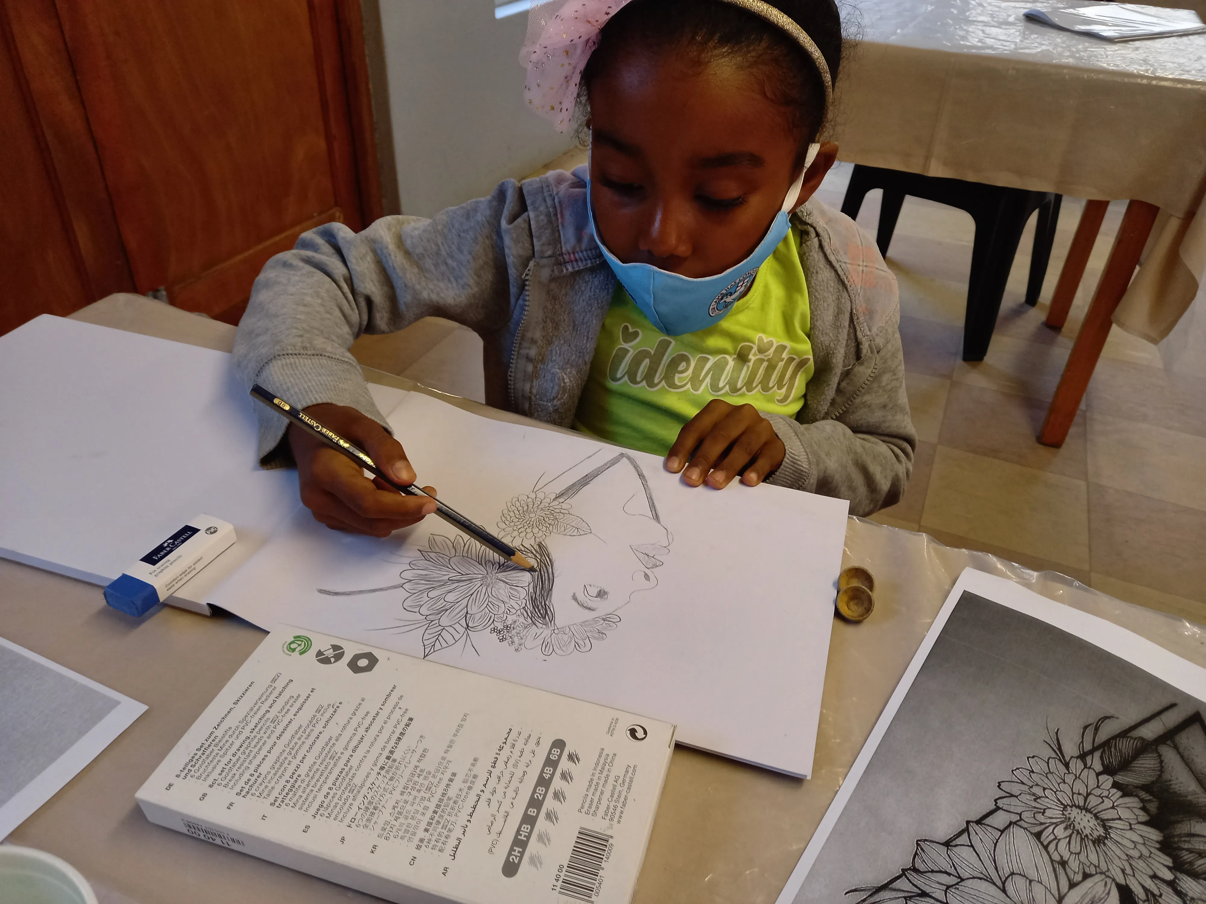 A young learner drawing during an art project